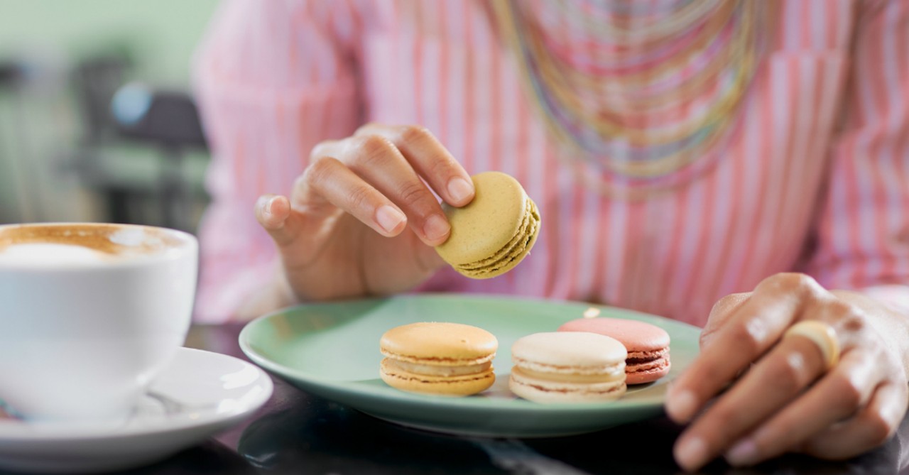 woman eating cookies with coffee