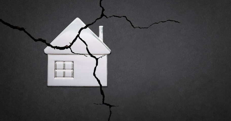 Illustration of a house with a giant crack across it