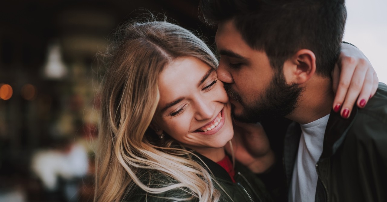 Husband kissing his wife's cheek